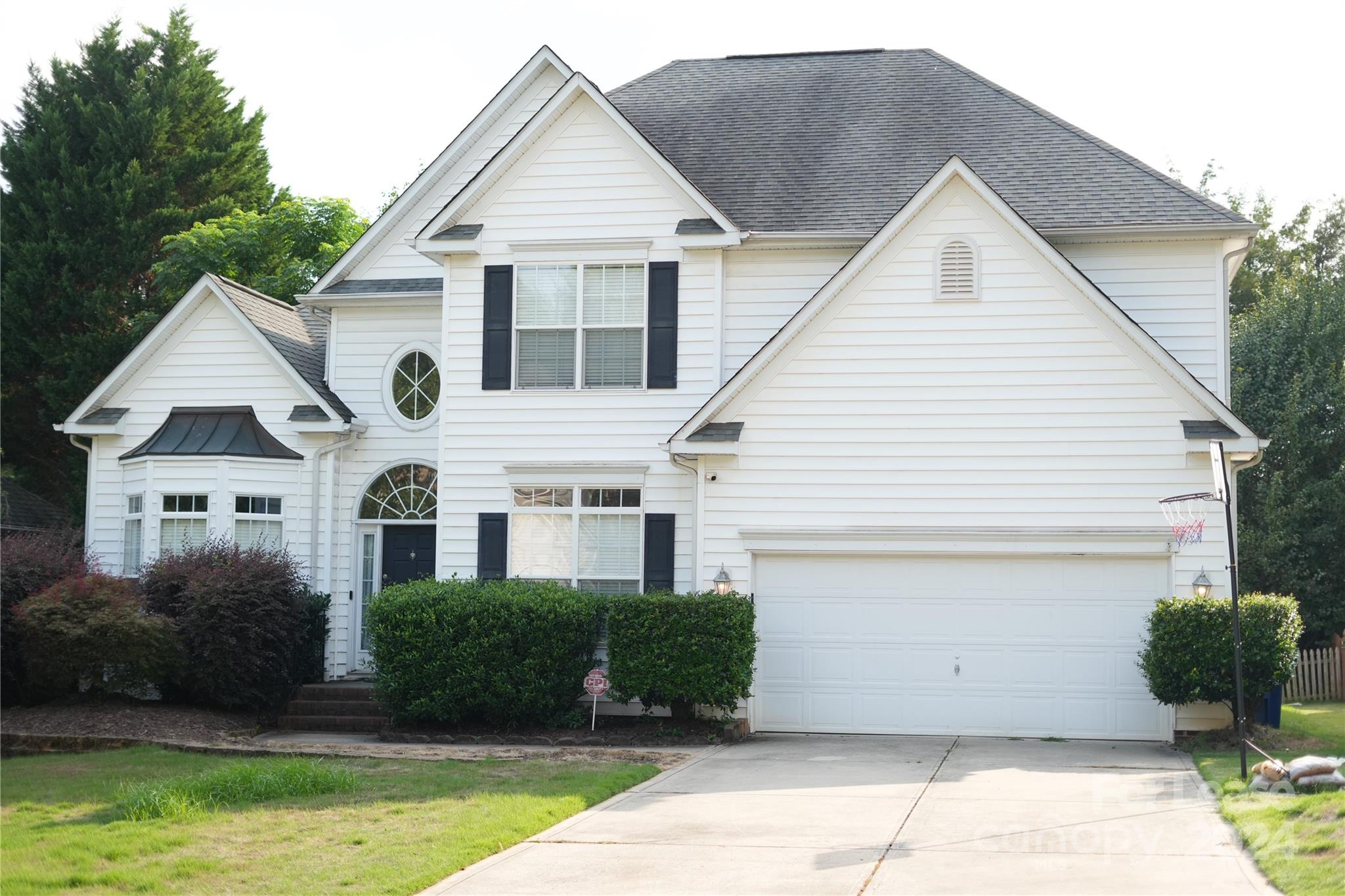 a view of a yard in front view of a house