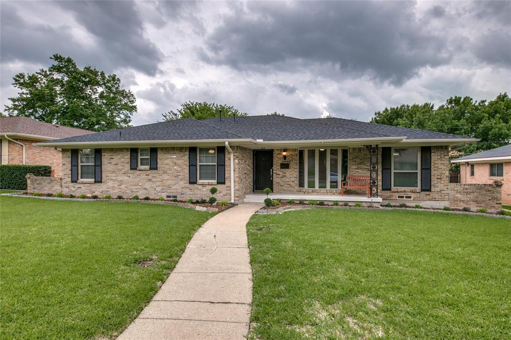 a front view of a house with yard patio and green space