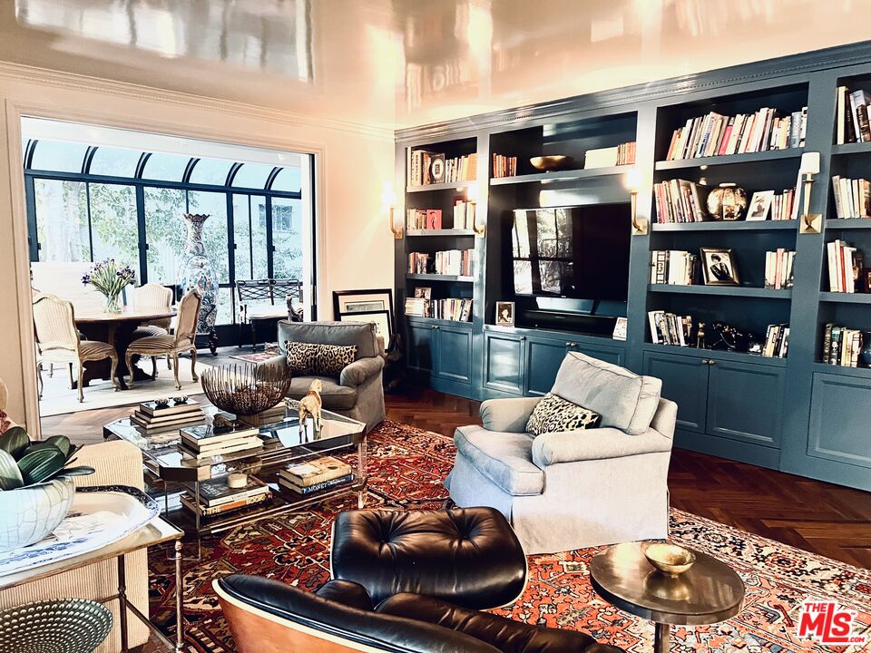 a living room with furniture and a book shelf