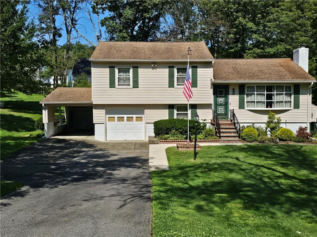 Tri-level home with a garage and car port