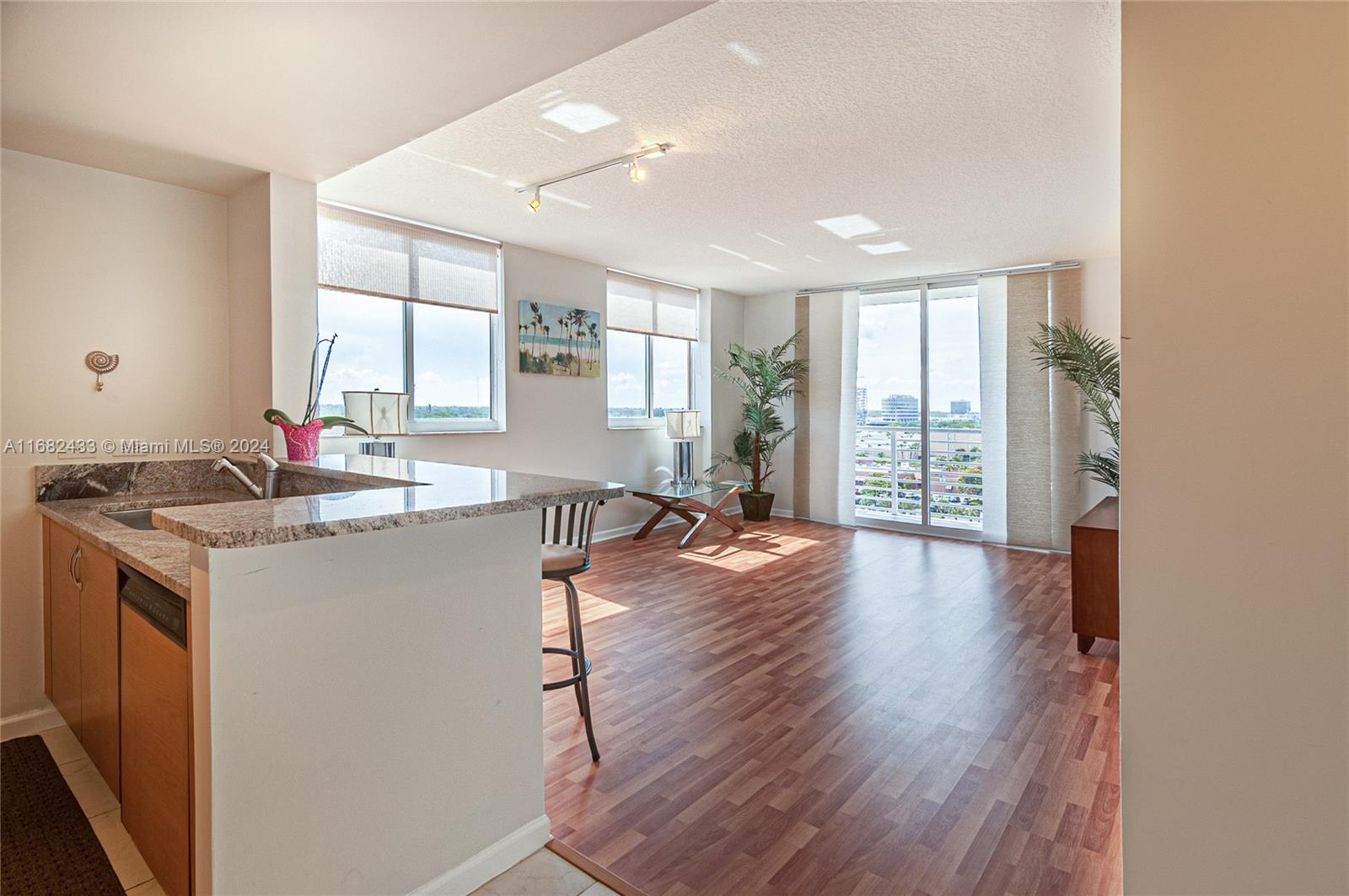 a kitchen with stainless steel appliances granite countertop a sink stove and wooden floor