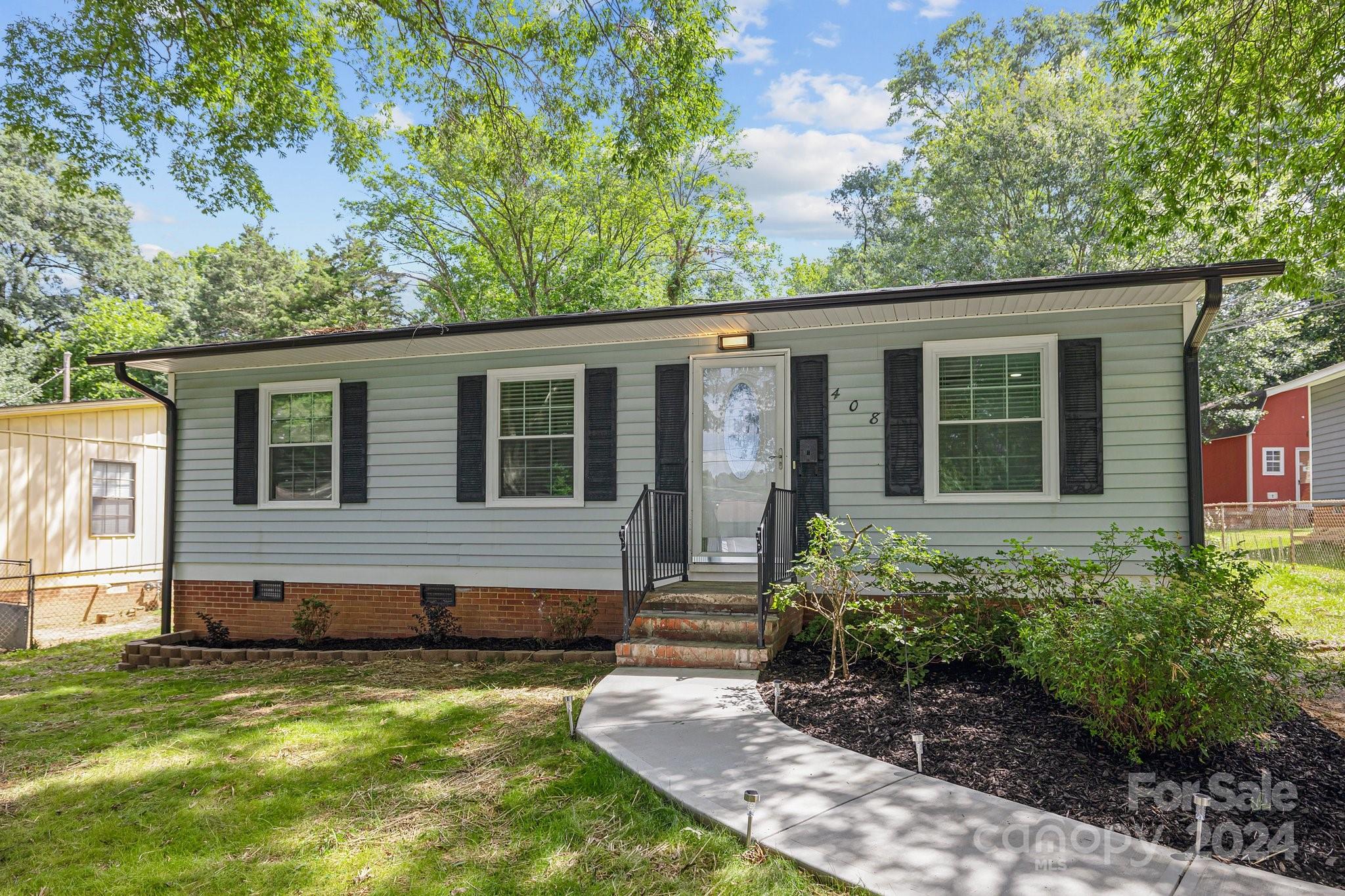 a view of house with backyard