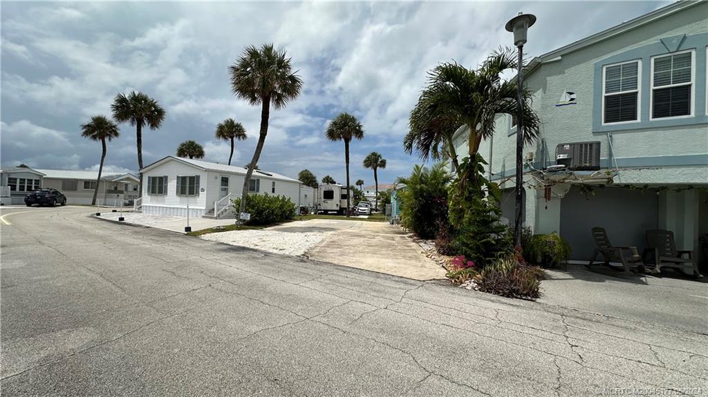 a view of multiple houses with palm trees