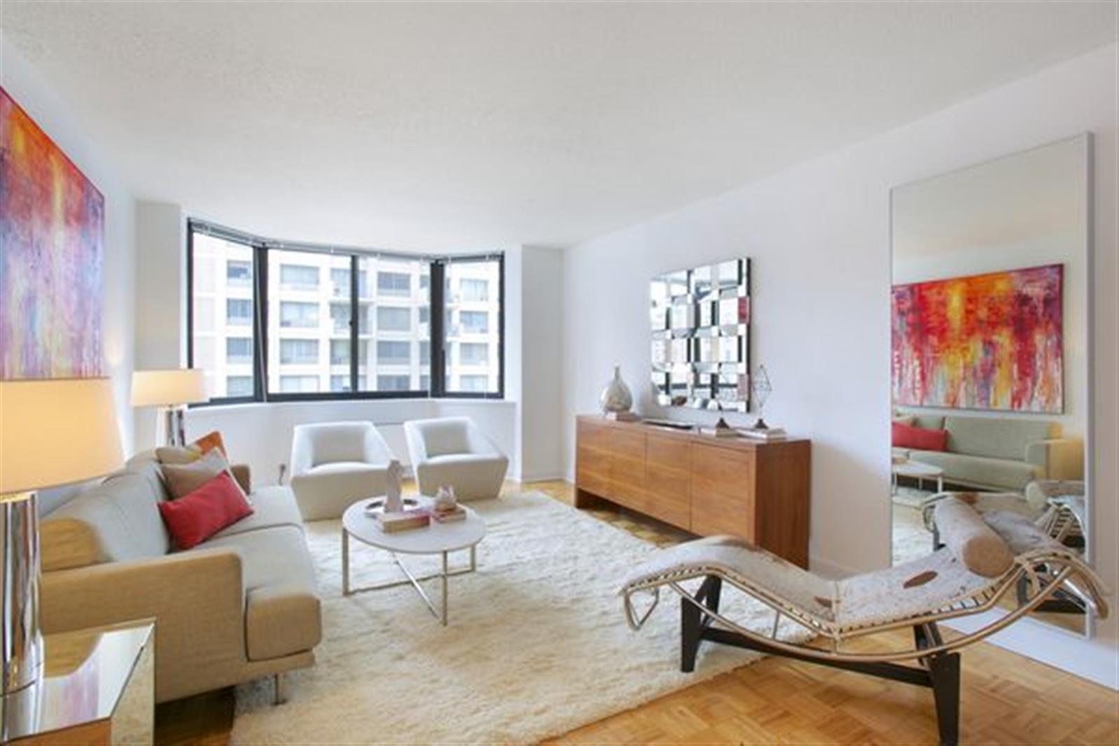 a living room with furniture a rug and a window