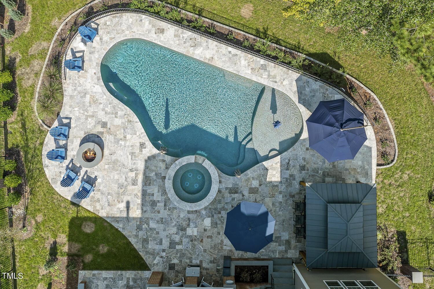 an aerial view of a house with garden space and swimming pool