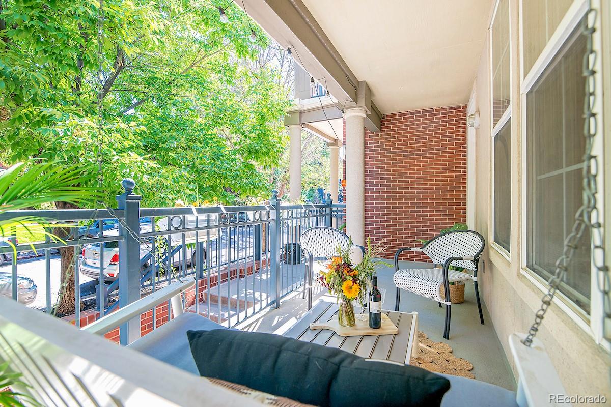 a view of a chairs and table in the balcony