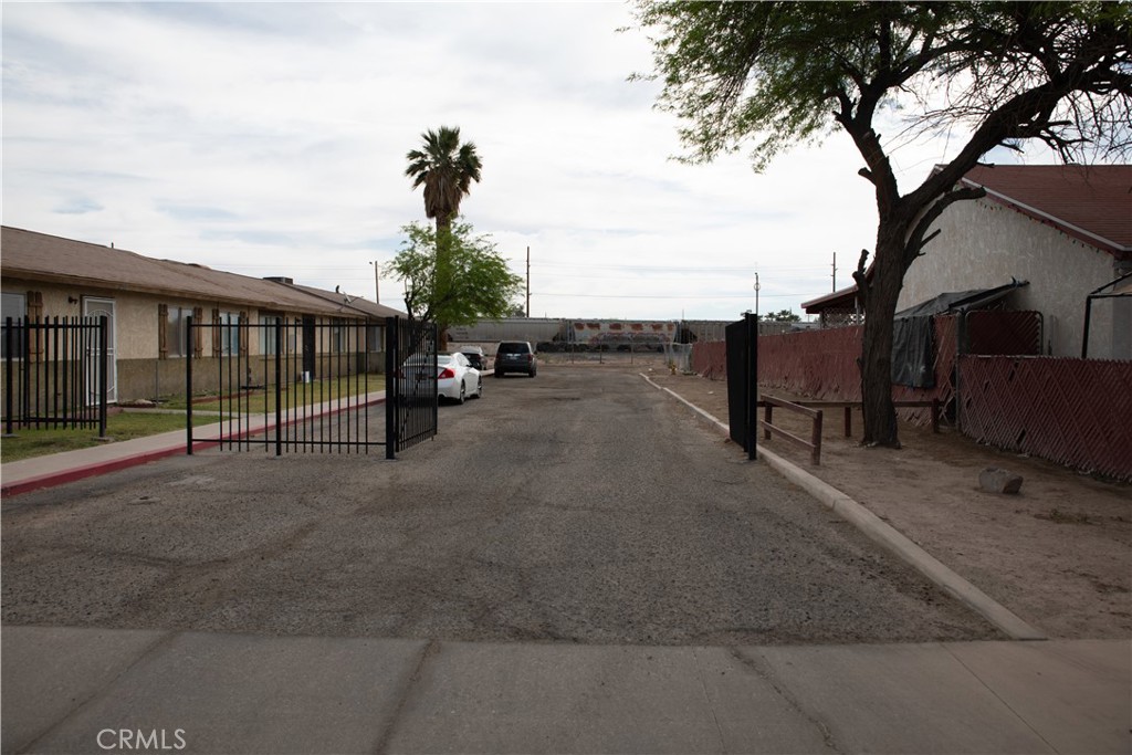 a view of street with wooden fence