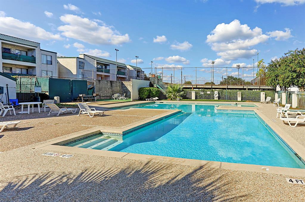 a swimming pool with outdoor seating and yard