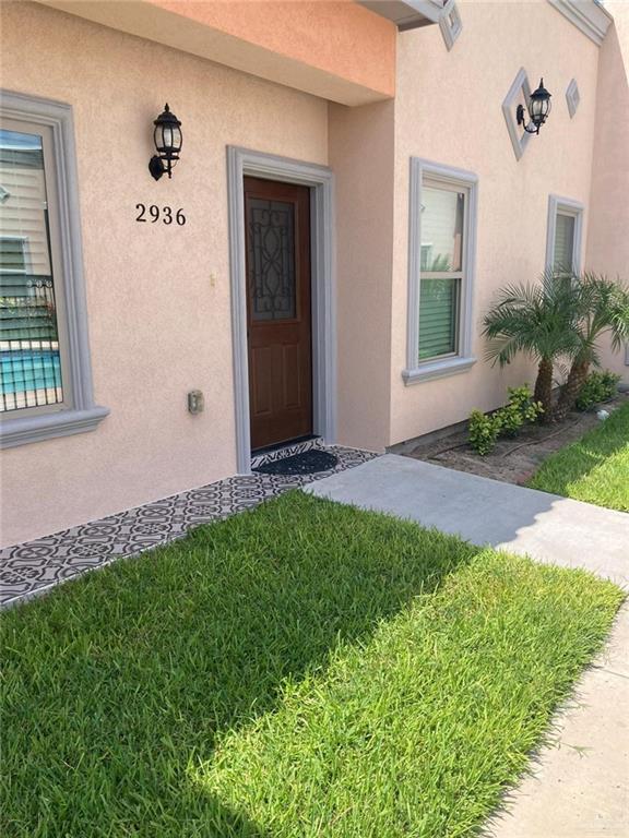 Doorway to property with a yard