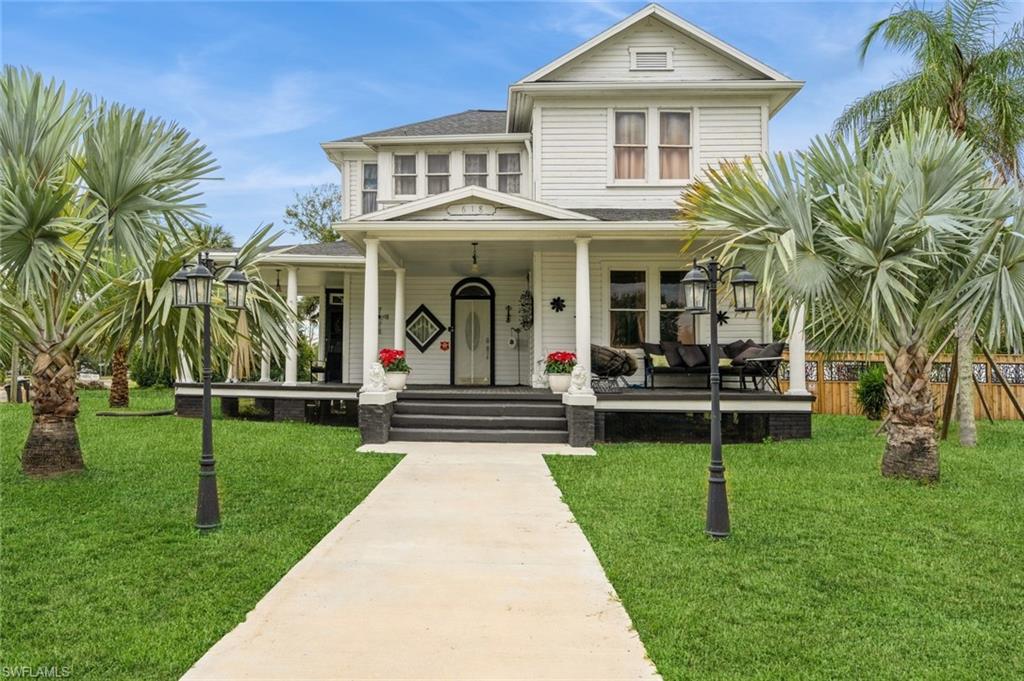 View of front facade with a porch and a front lawn