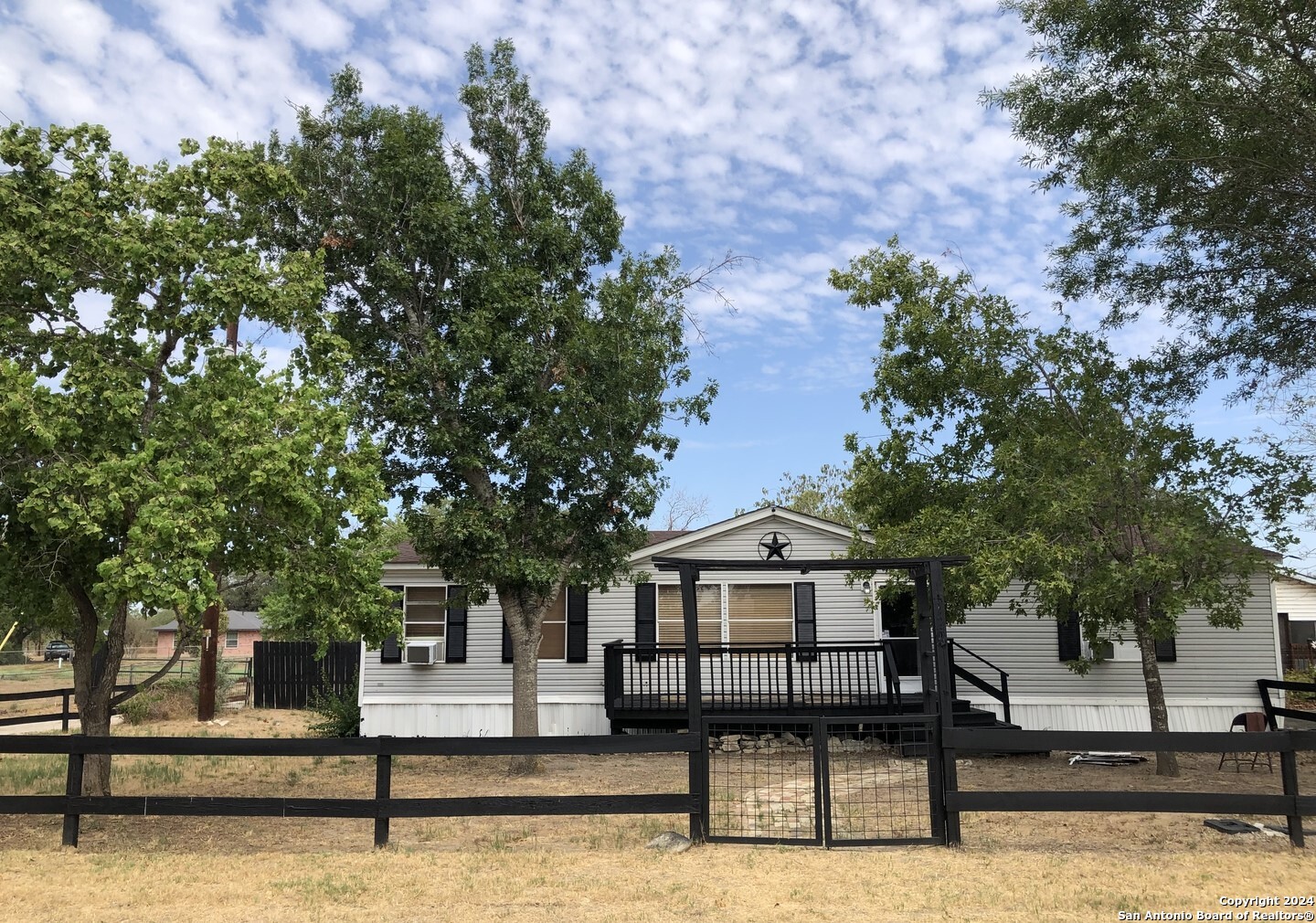 a front view of a house with a bench