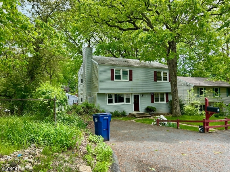 a view of a house with a backyard