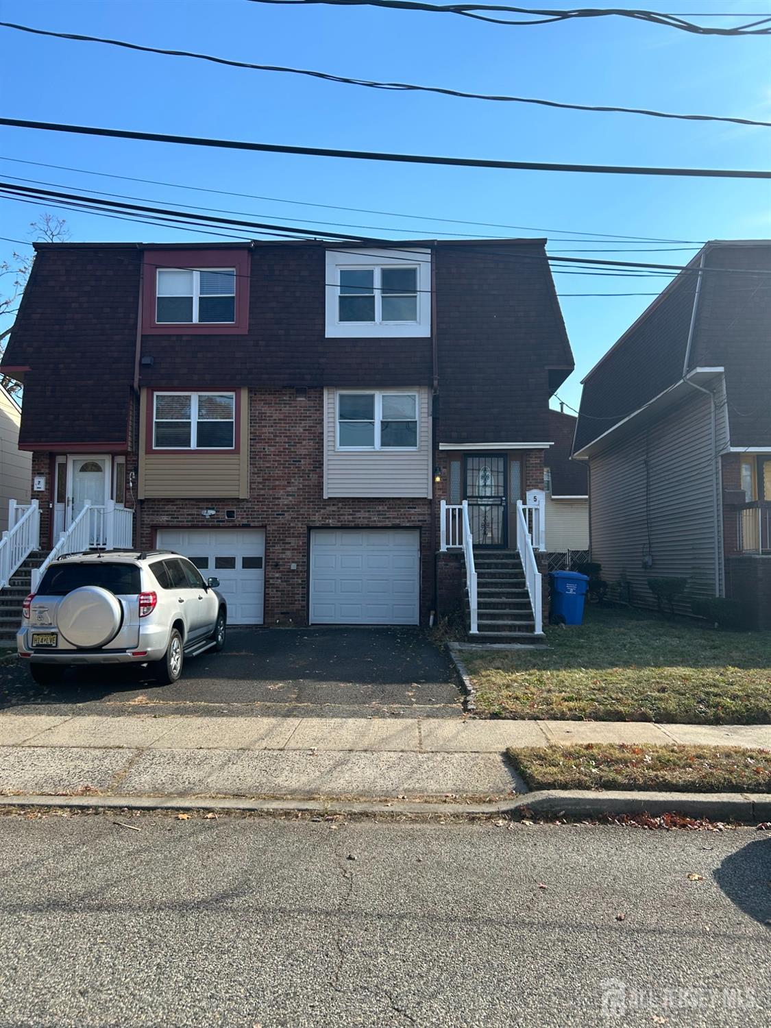 a view of a car parked front of a house