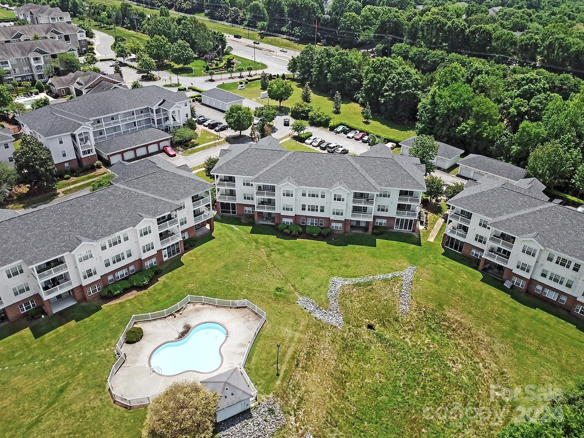 an aerial view of a house with yard swimming pool and outdoor seating