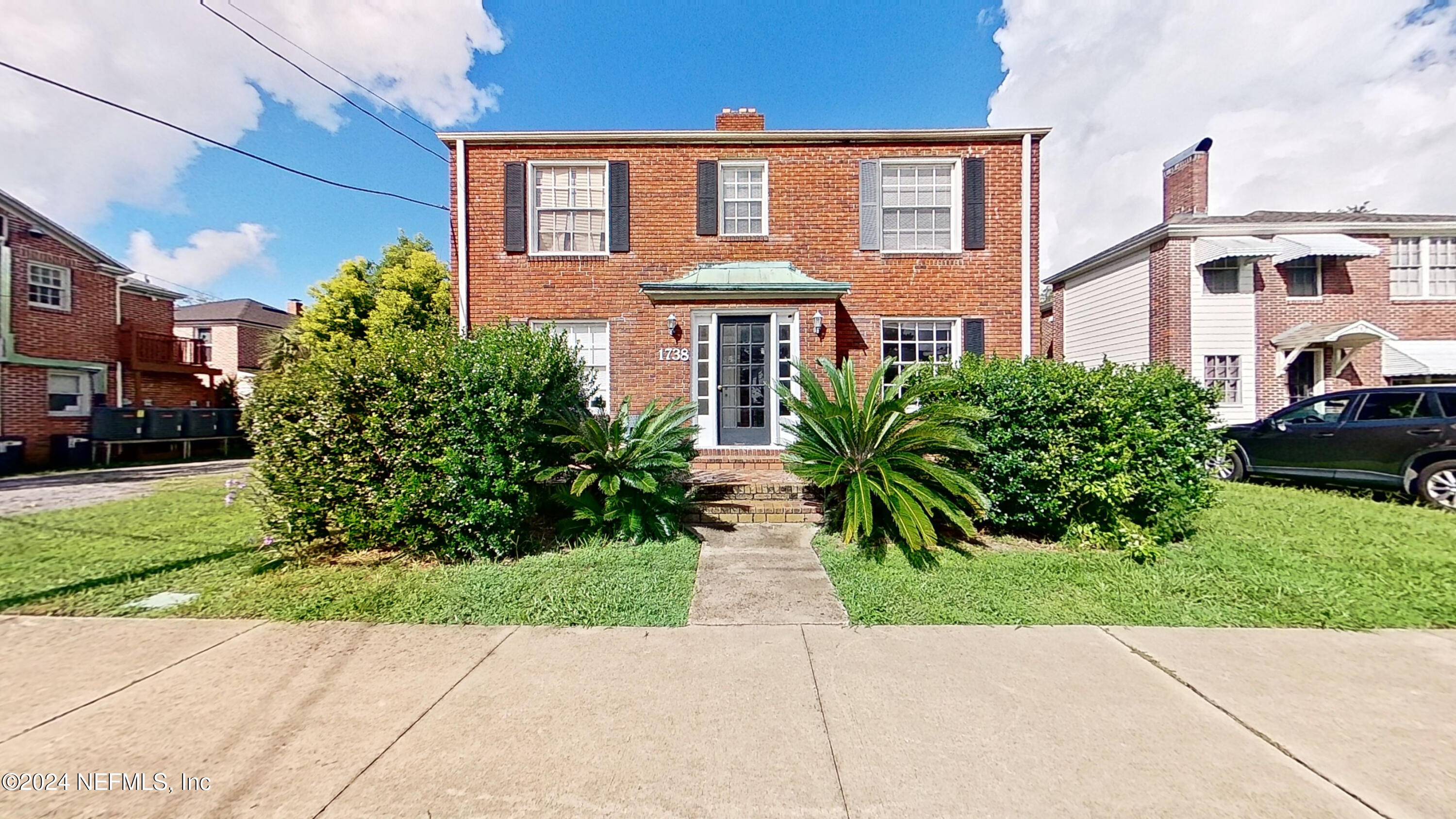 a front view of a house with garden