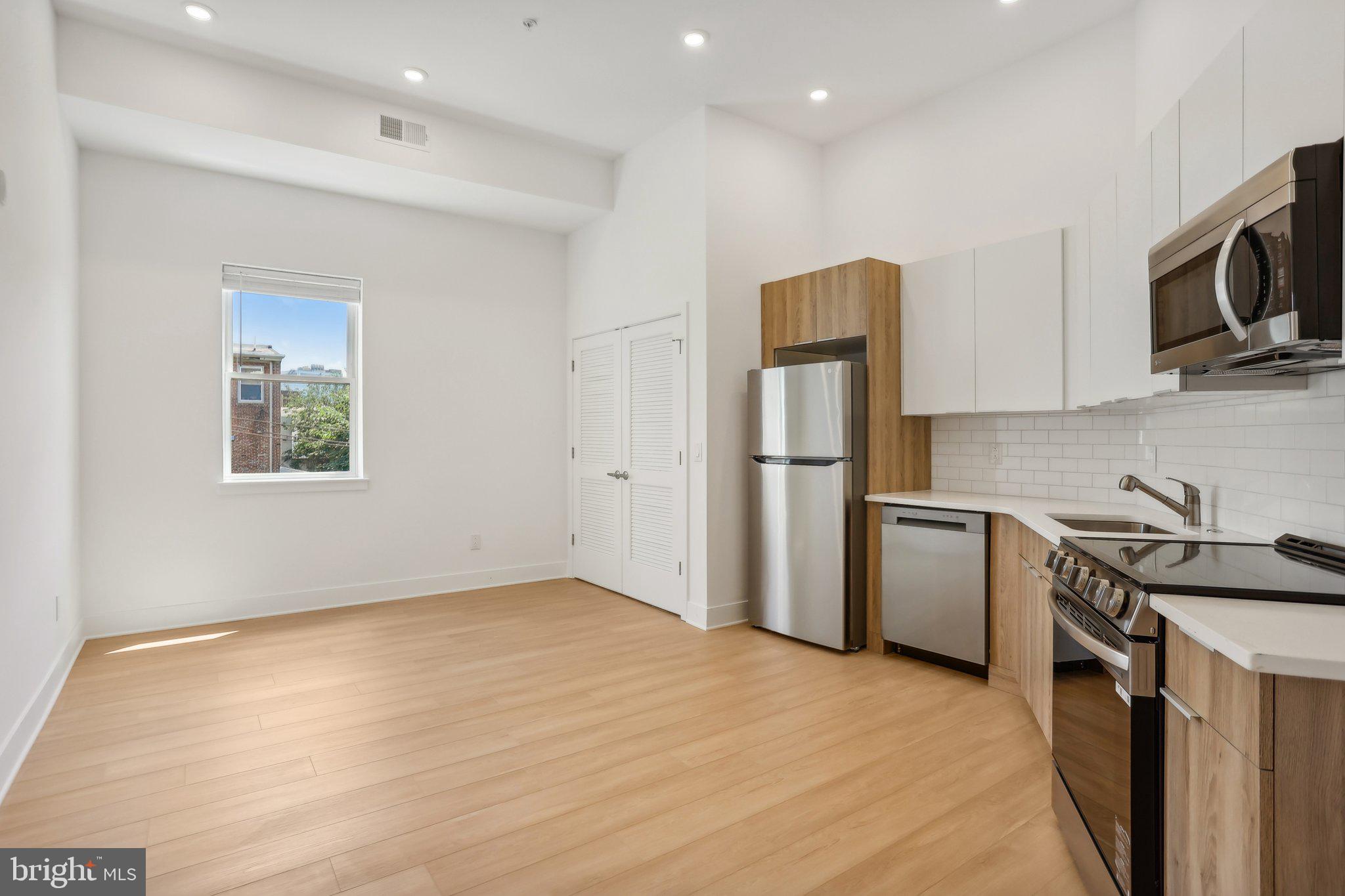 a kitchen with a refrigerator stove and microwave