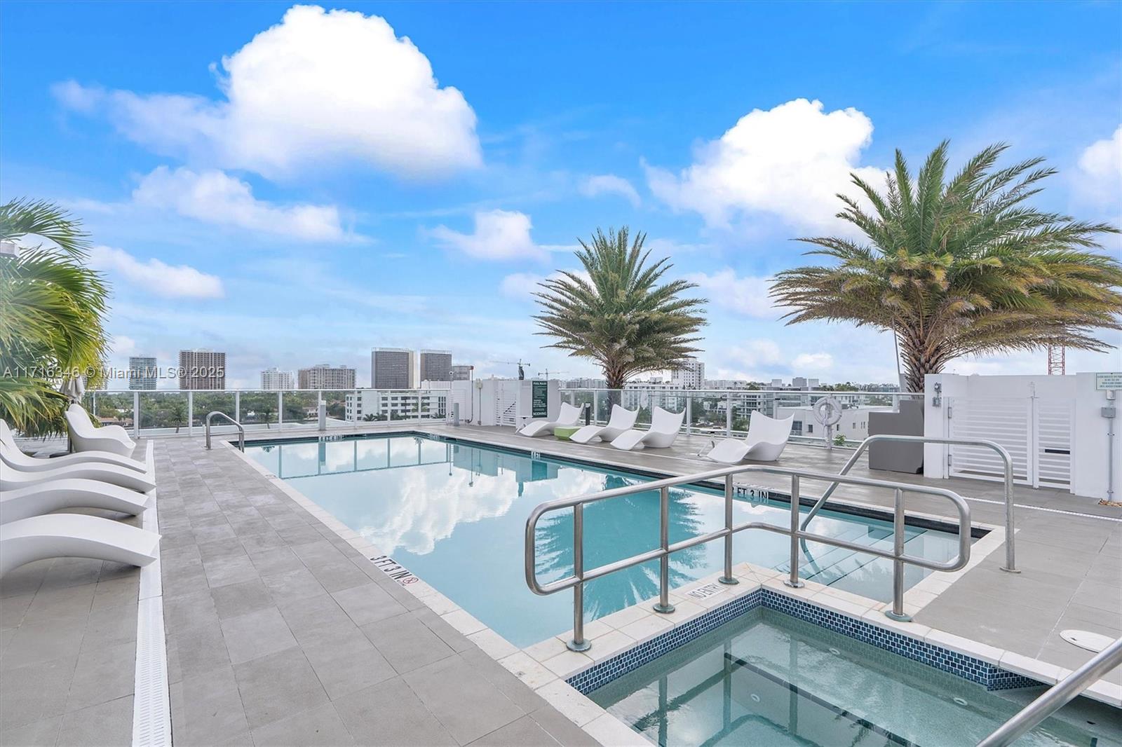 a view of a swimming pool with a table and chairs