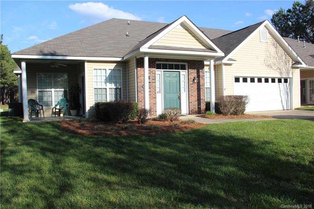 a front view of a house with a yard and porch