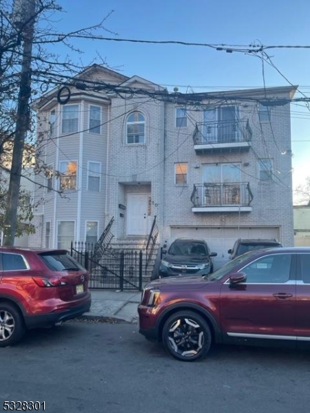 a front view of a house with parking space