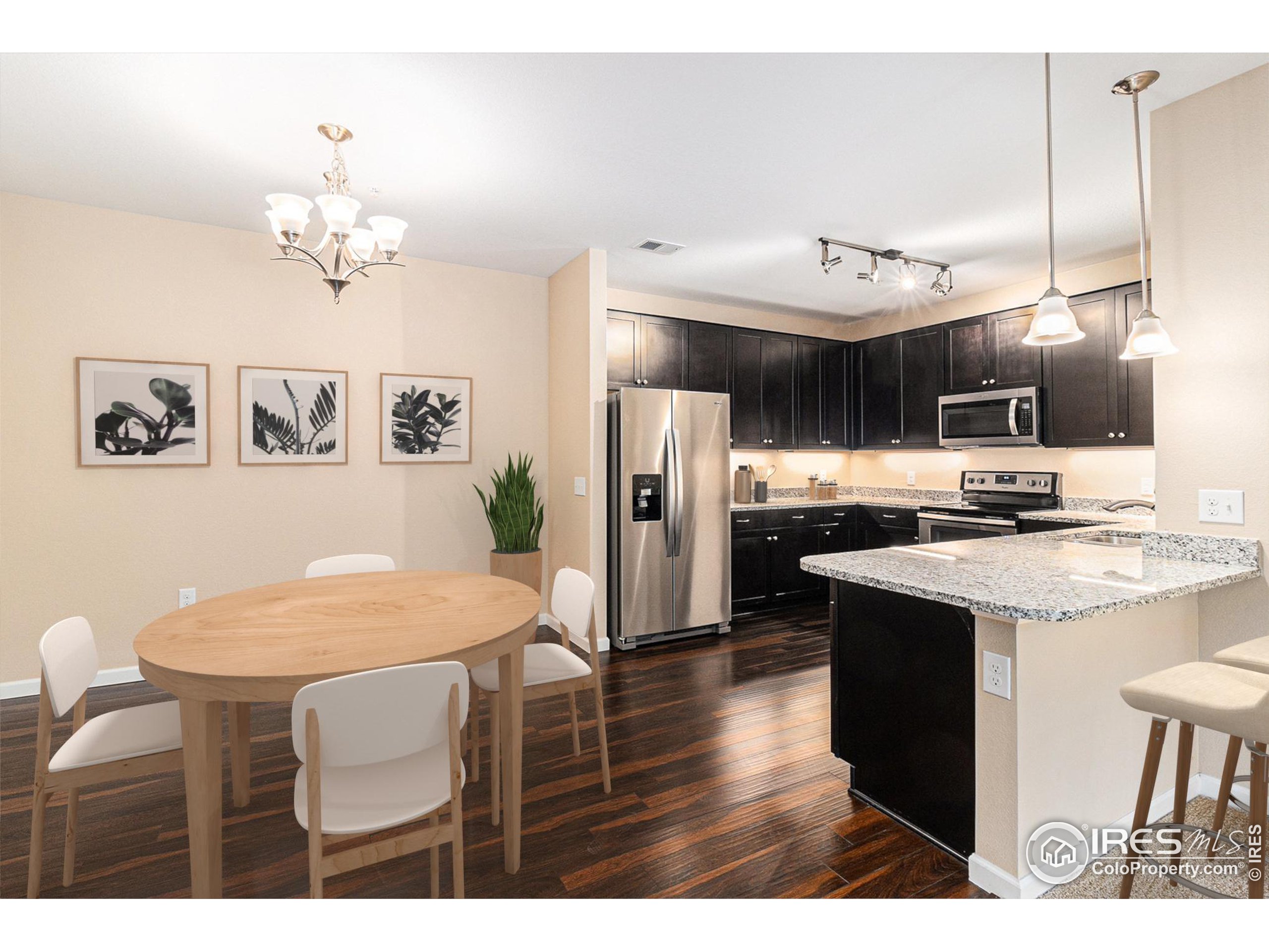 a kitchen with kitchen island granite countertop a sink cabinets and stainless steel appliances