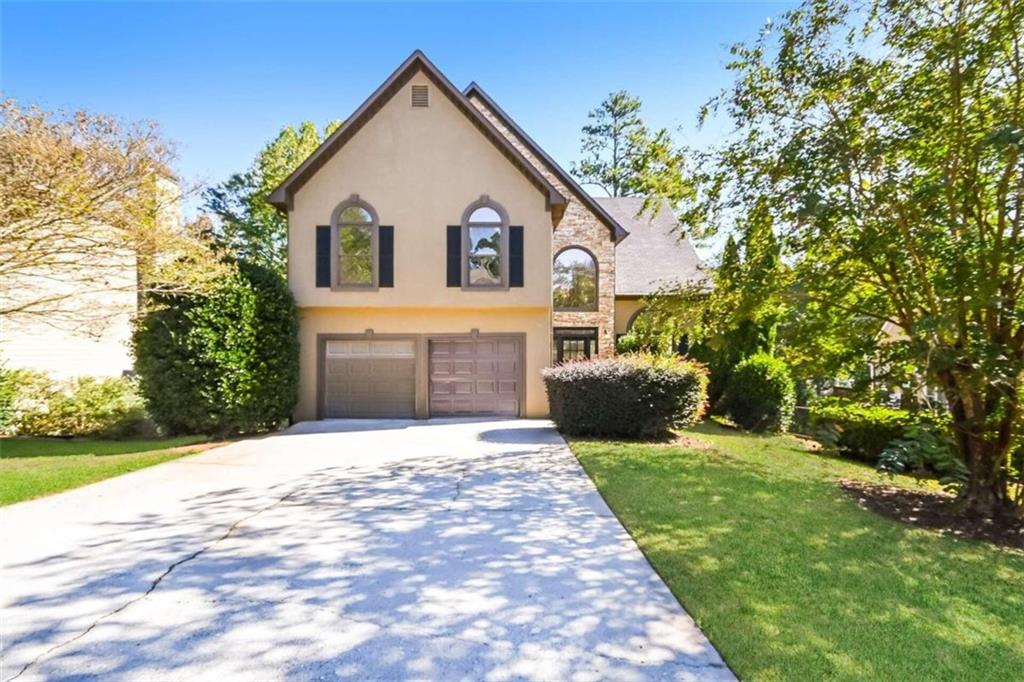 a front view of a house with a yard and garage