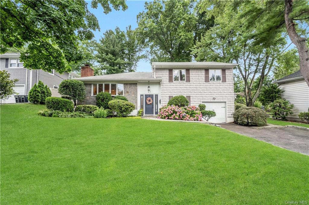 a front view of house with yard and green space