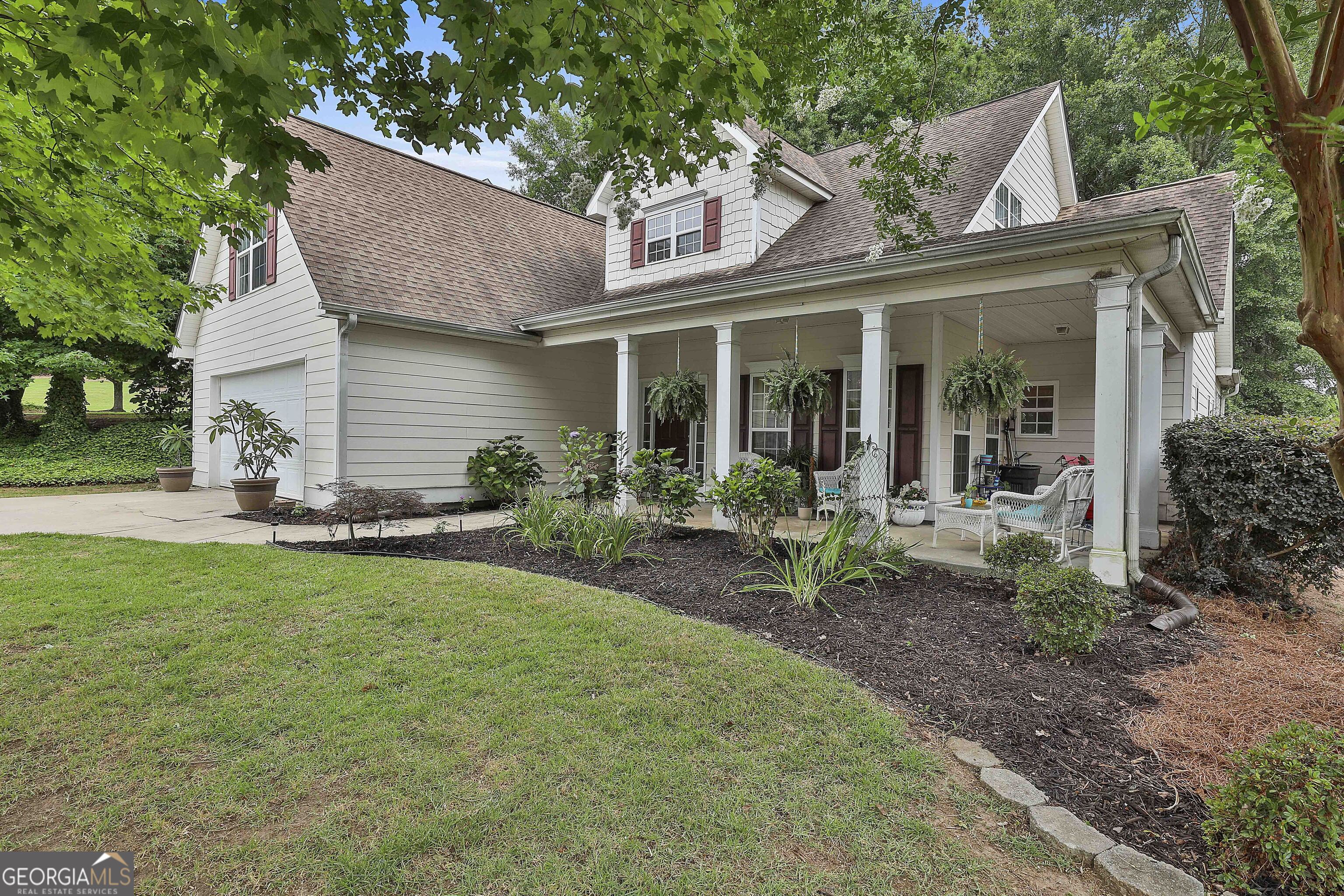 a view of a house with backyard sitting area and garden