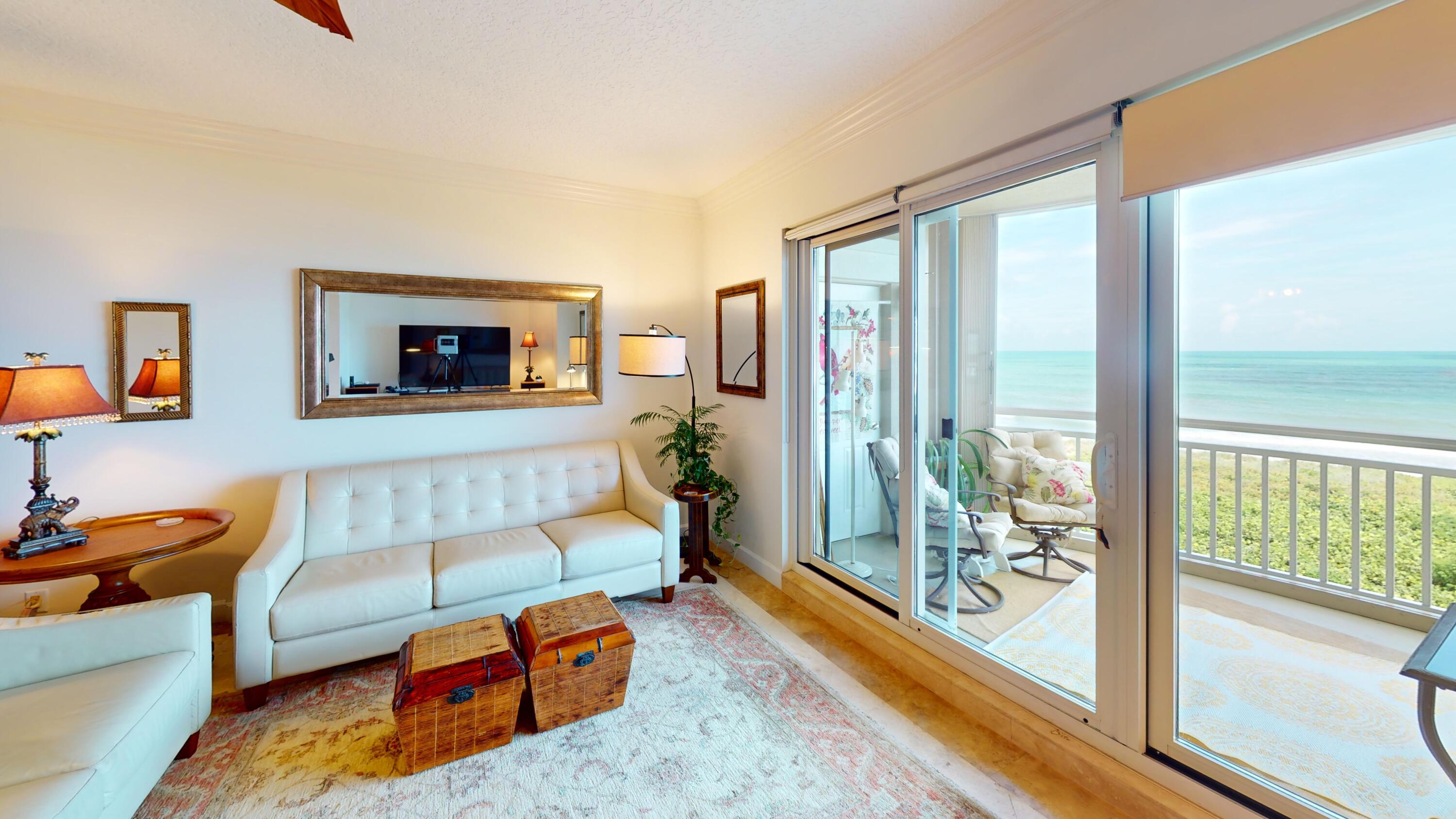 a living room with furniture and a floor to ceiling window