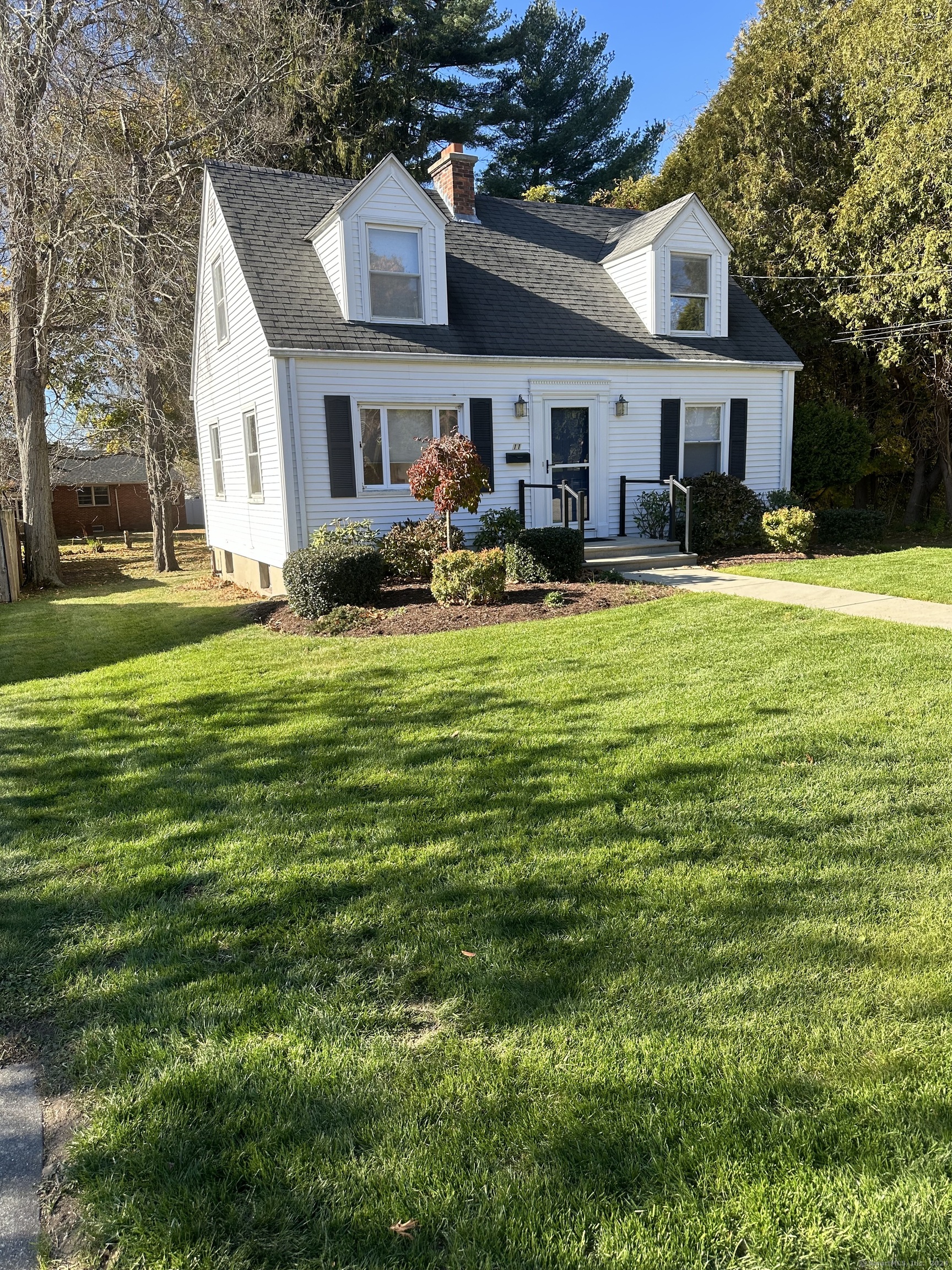 a front view of a house with swimming pool having outdoor seating