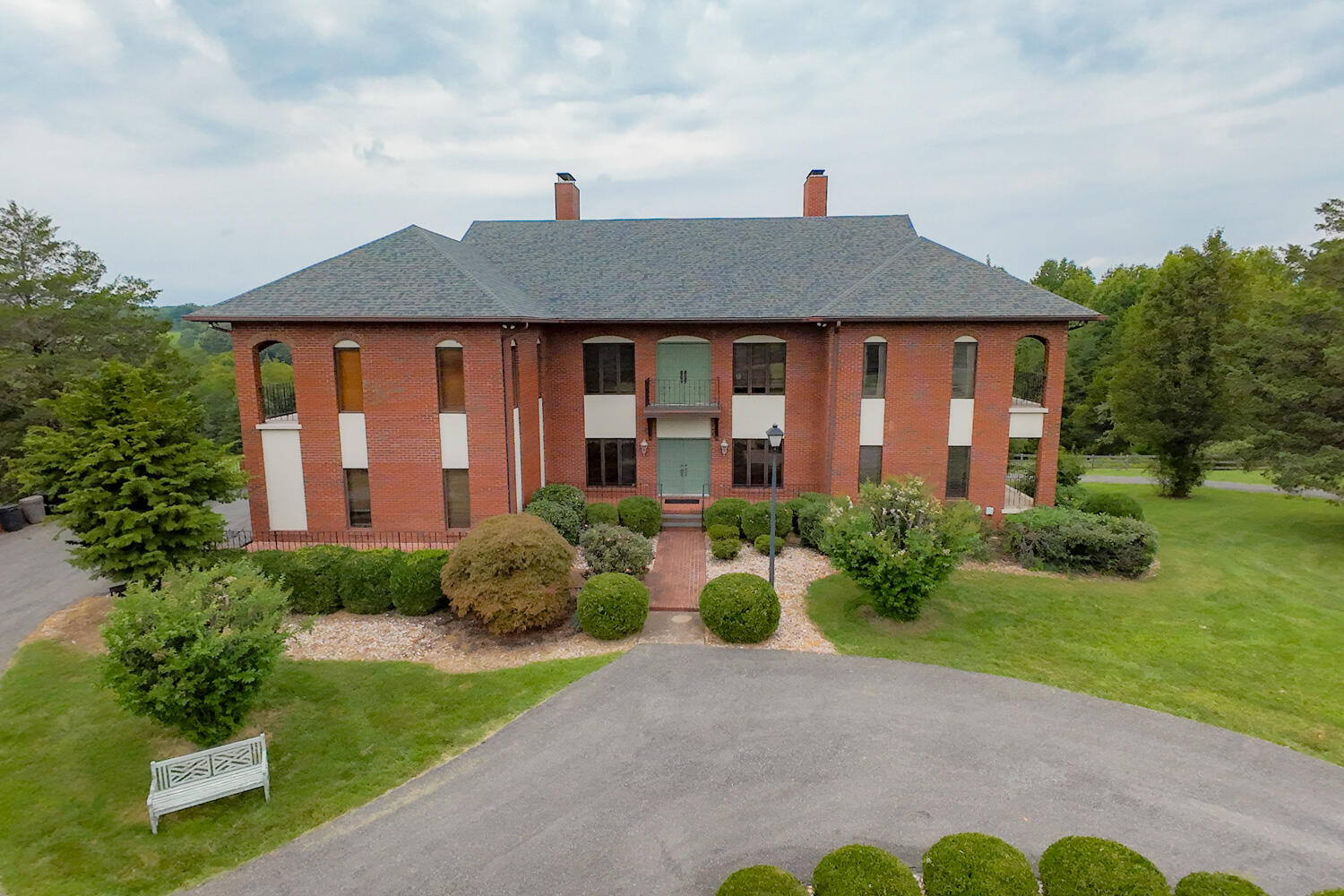 a front view of house with yard and green space