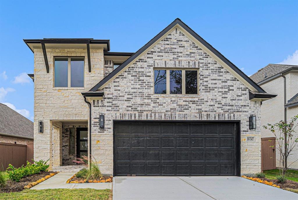 a front view of a house with garage