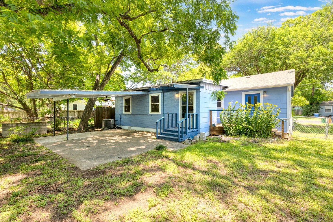 a view of a house with a yard and potted plants