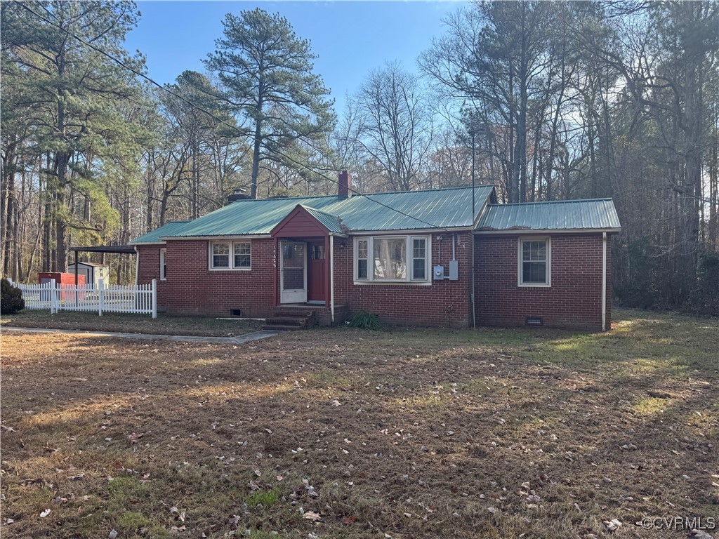 Single story home featuring a front lawn