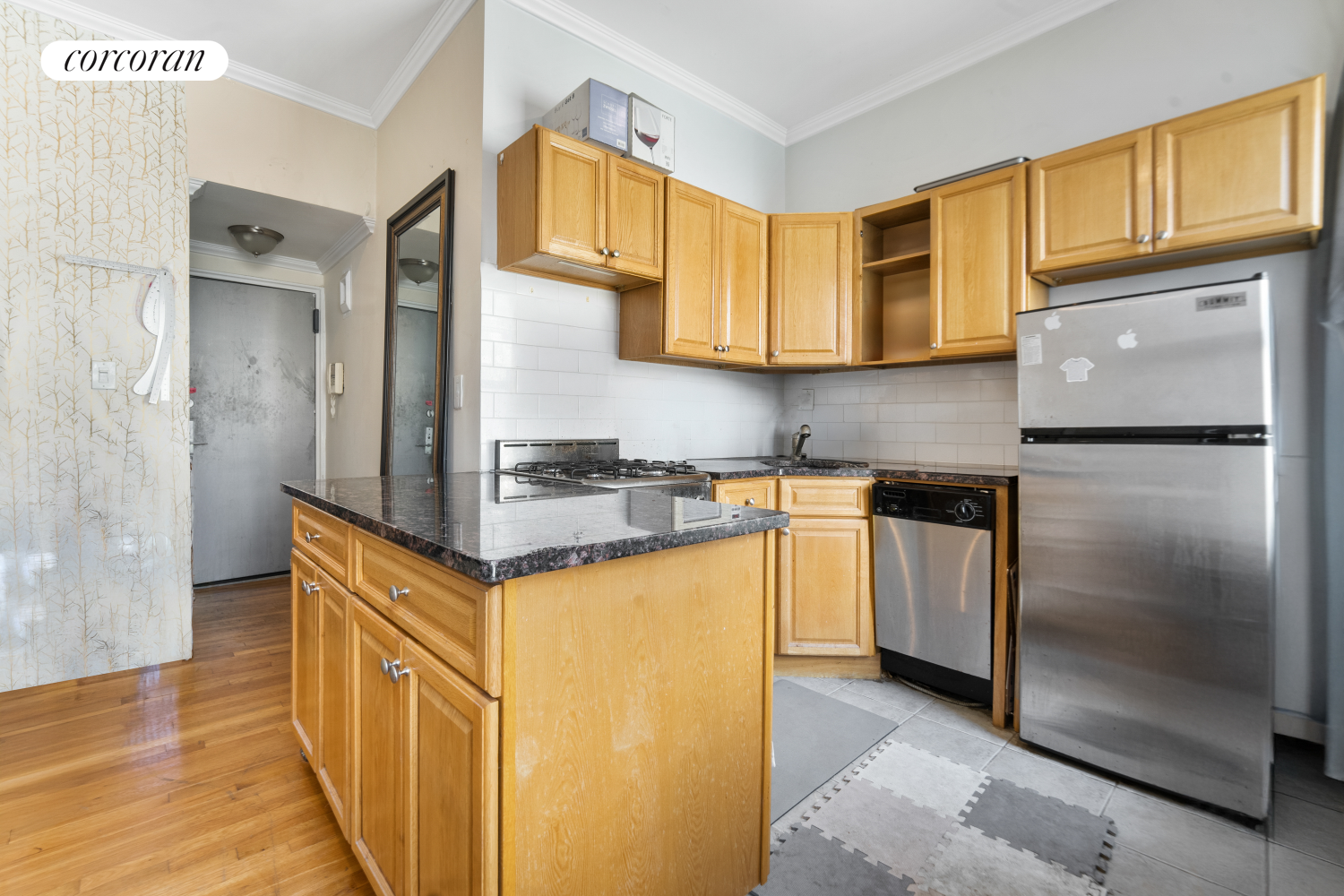 a kitchen with granite countertop a refrigerator and a stove top oven