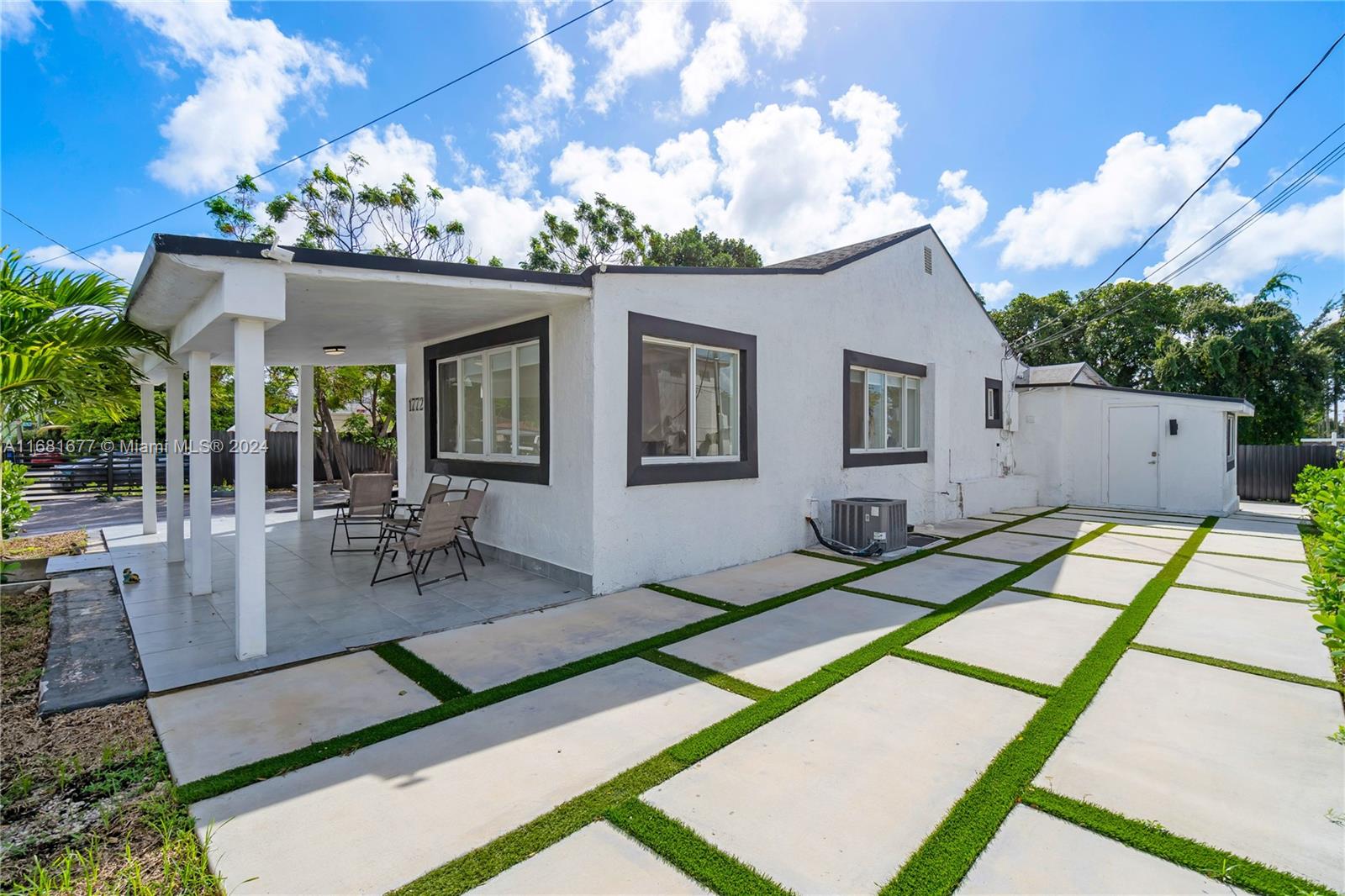 a view of a house with backyard porch and sitting area