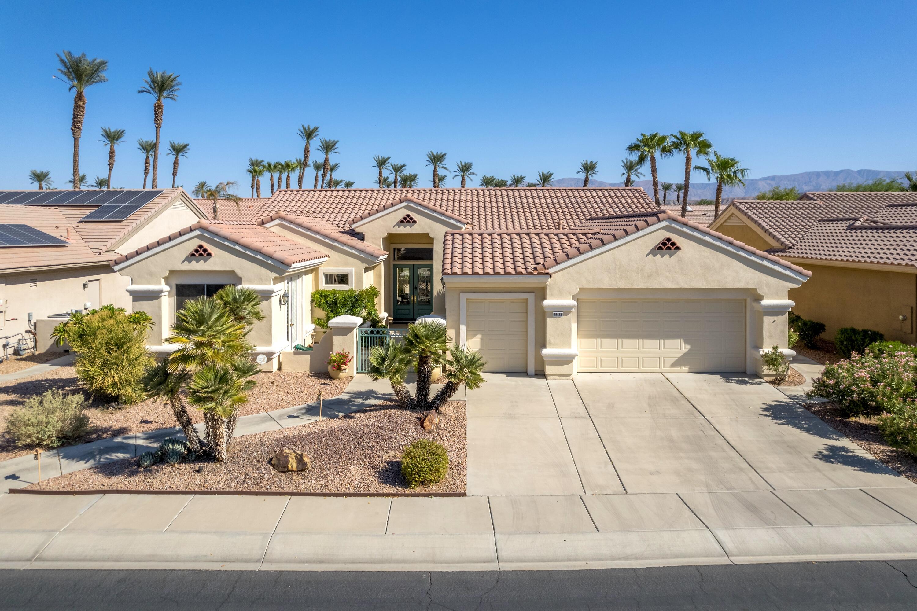 a front view of a house with a yard and a garage