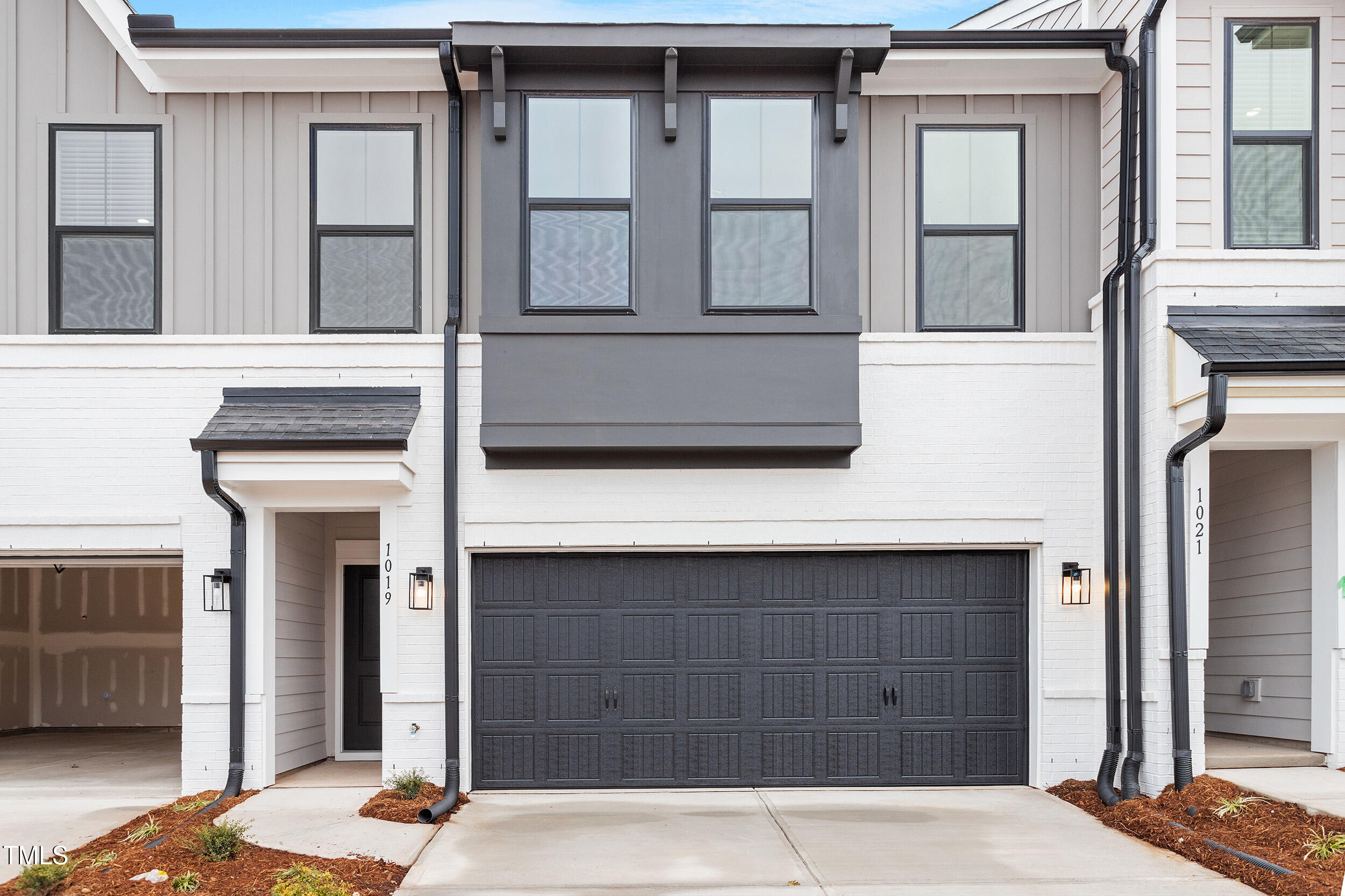 a front view of a house with a garage