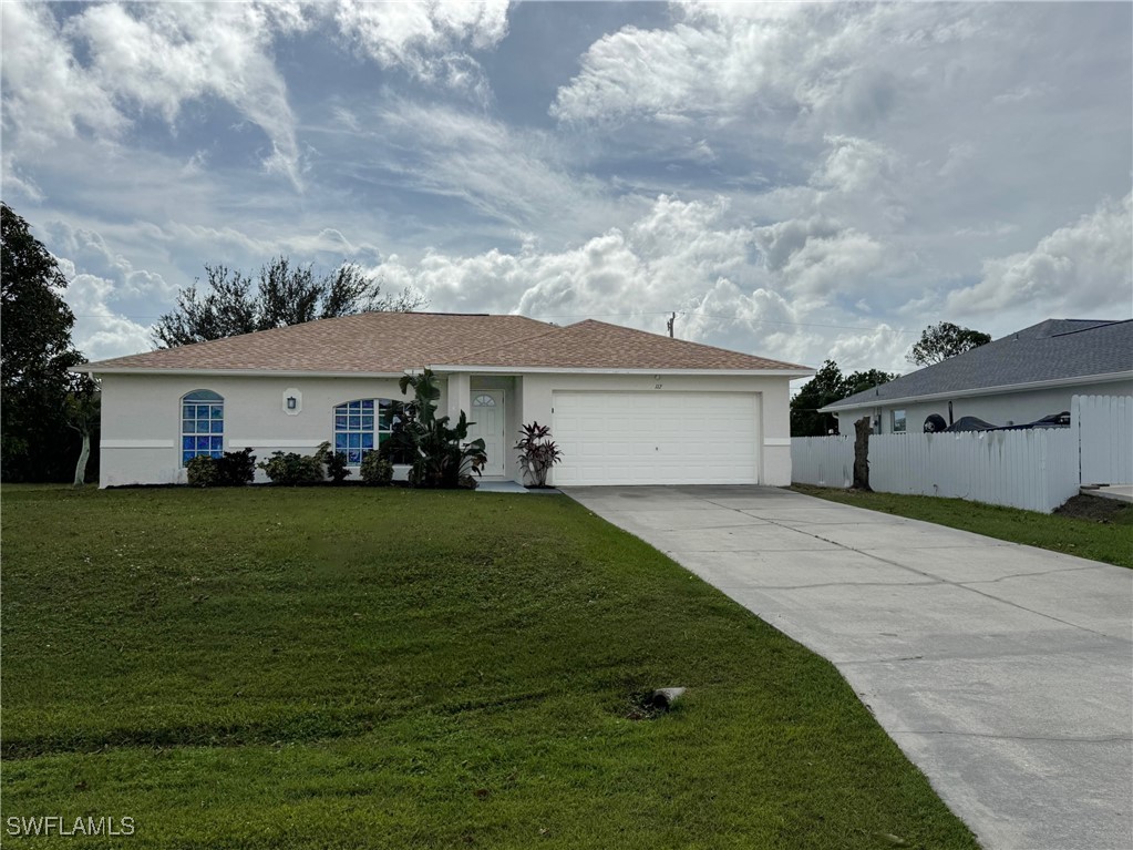 a front view of a house with a garden