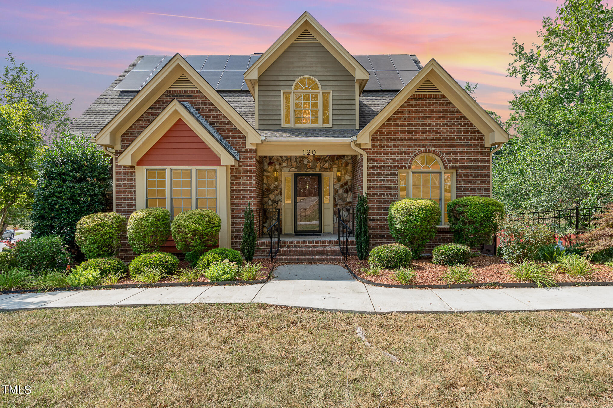 a front view of a house with a yard