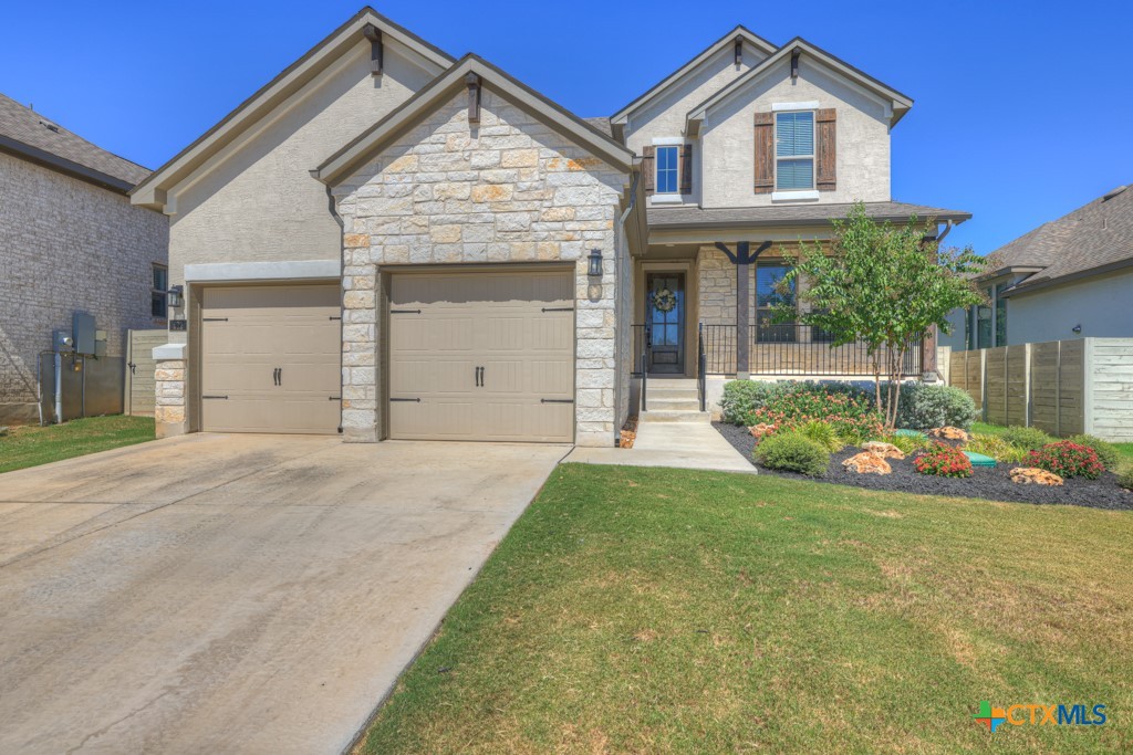 a view of a house with a yard and garage