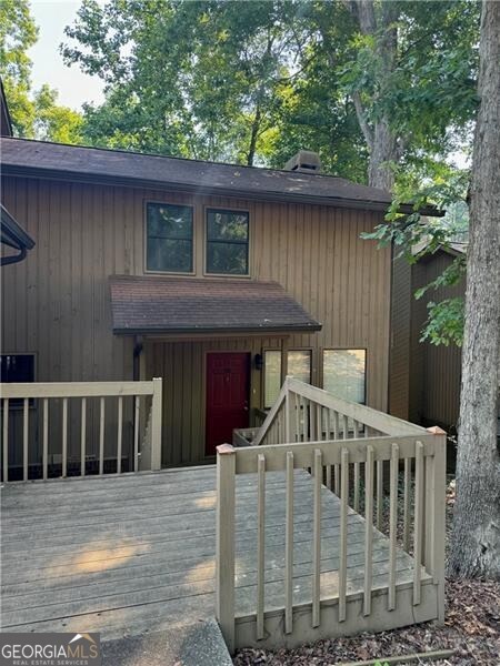 View of front of property featuring a wooden deck