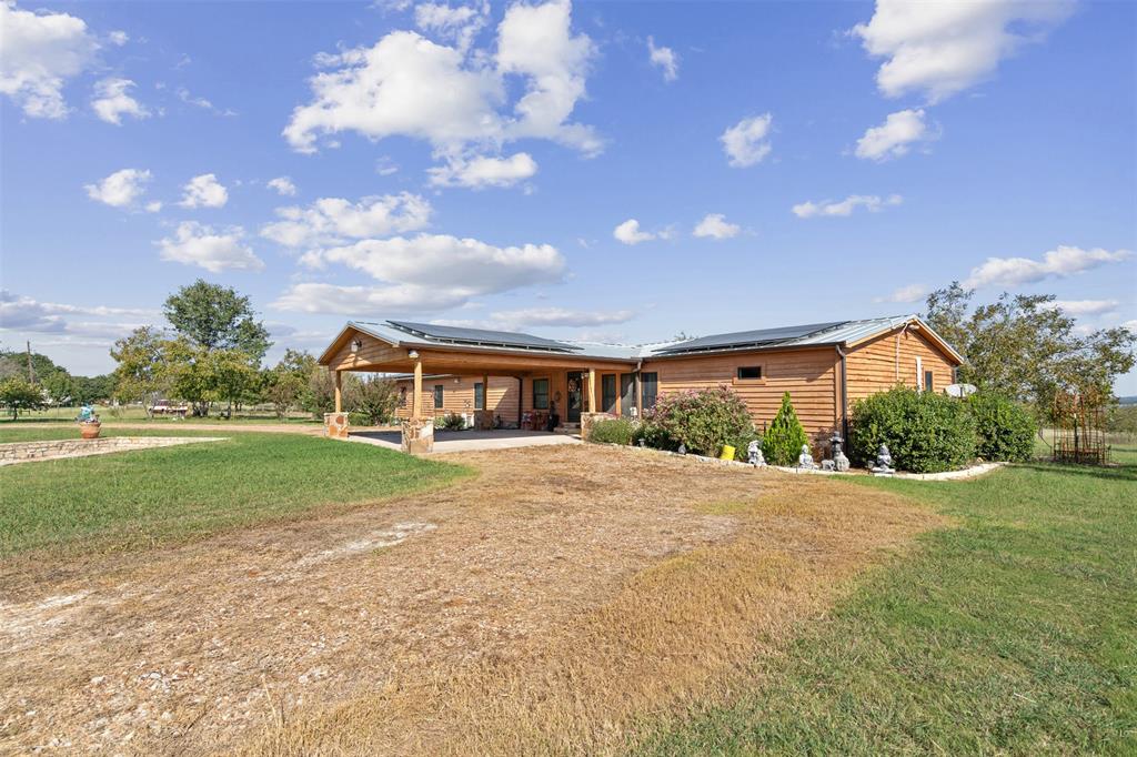 a front view of house with yard and green space