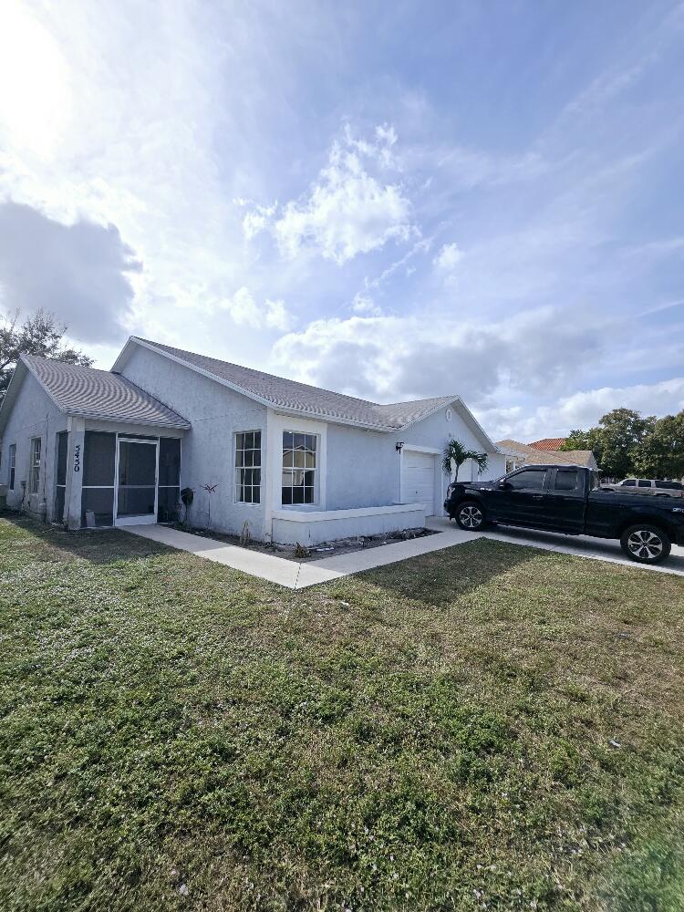 a view of a house with a backyard