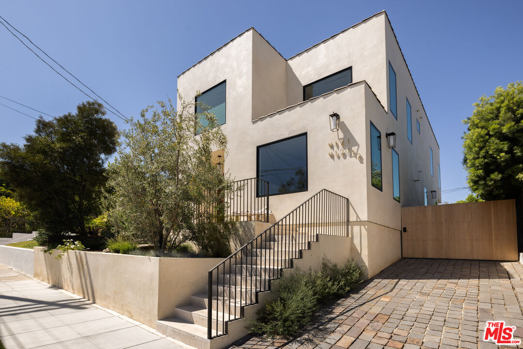 a view of a white building with many windows