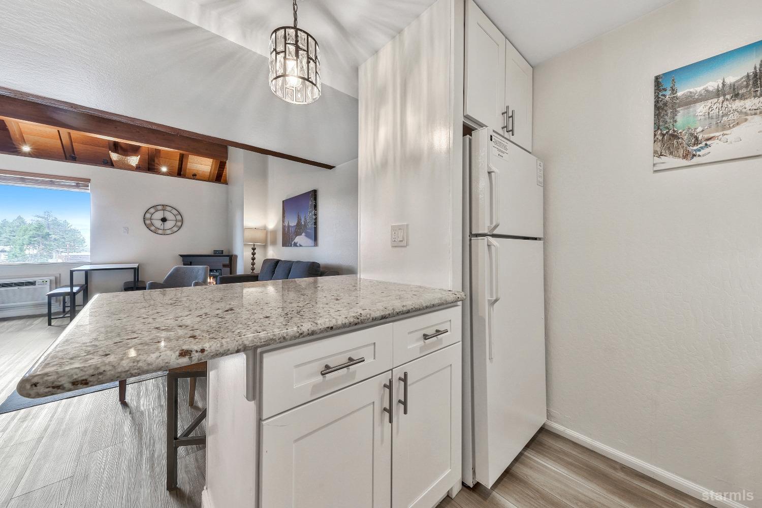 a kitchen with a table and refrigerator