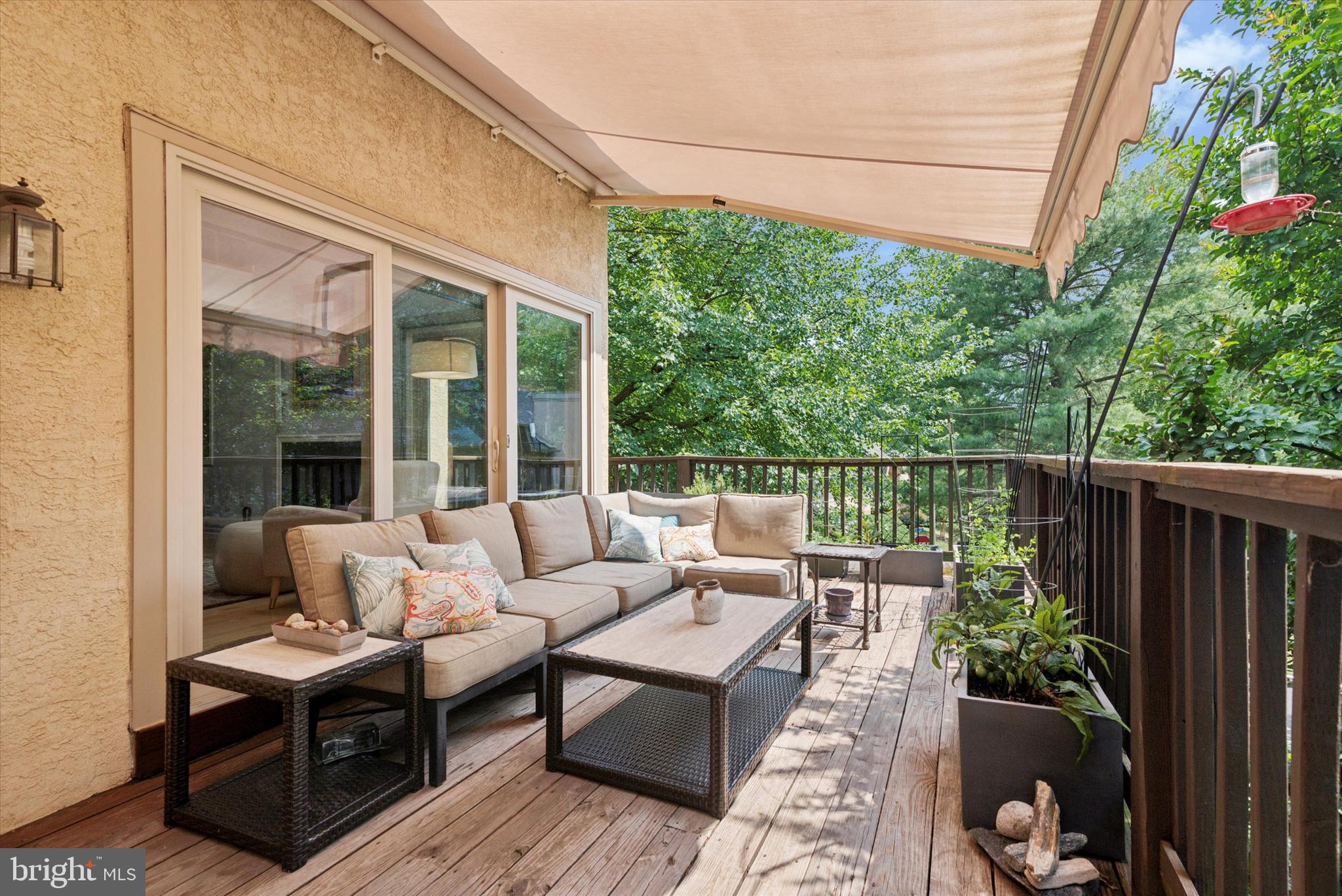 a balcony with wooden floor and outdoor seating