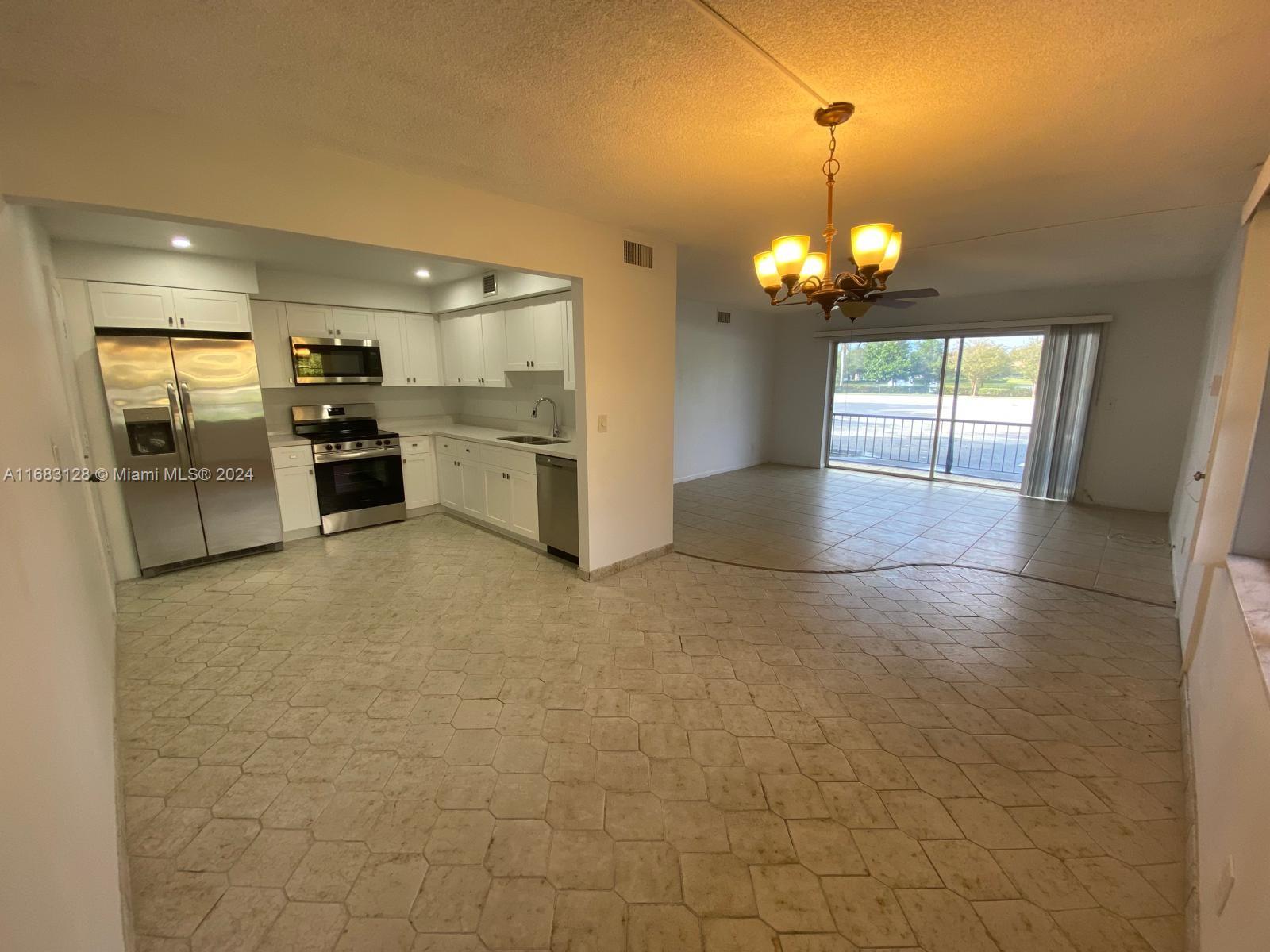 a view of a kitchen with a sink and cabinets