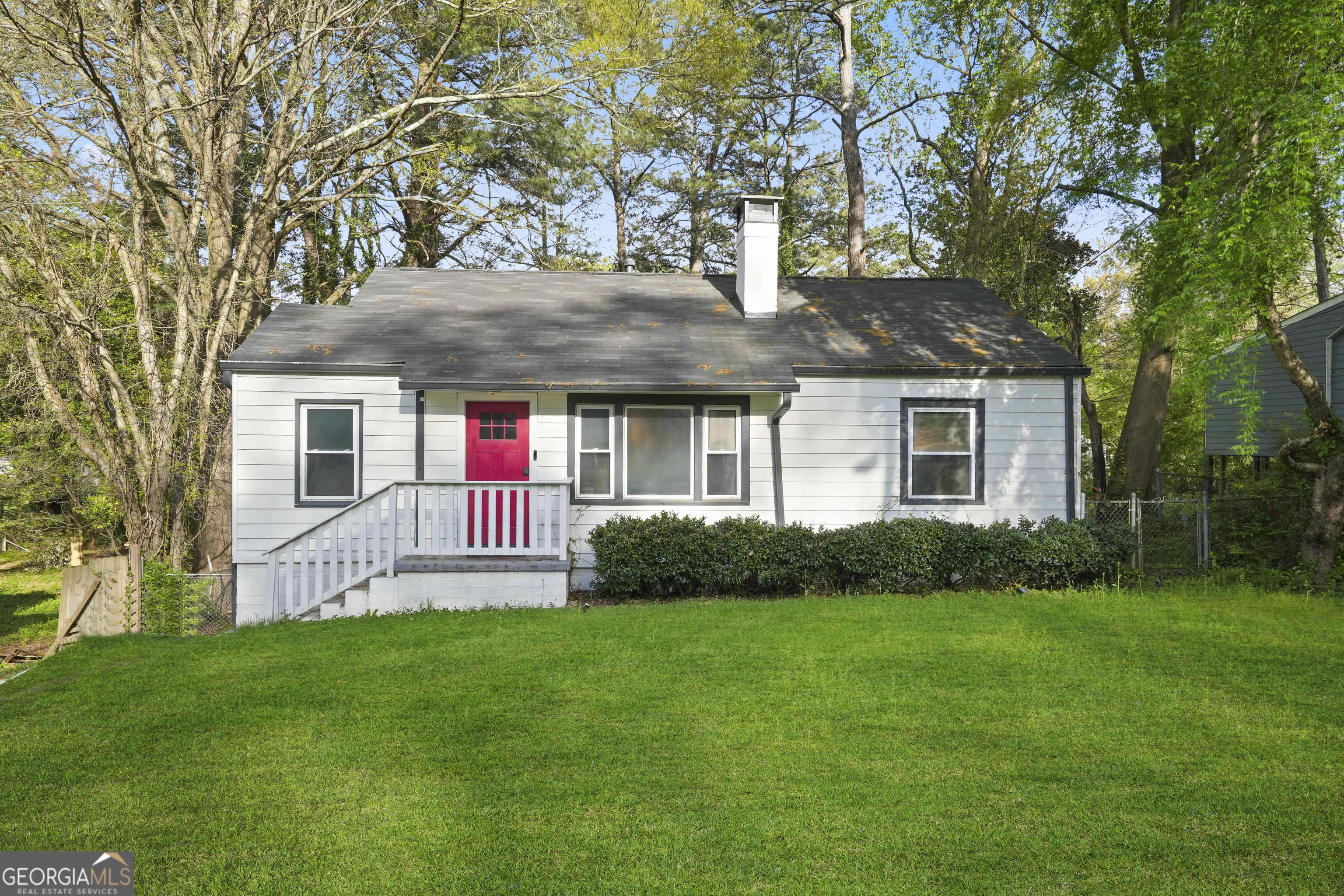 a front view of house with yard and green space