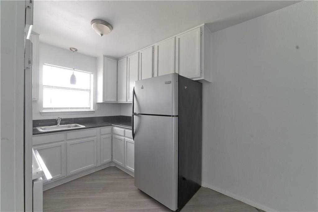 a white refrigerator freezer sitting inside of a kitchen