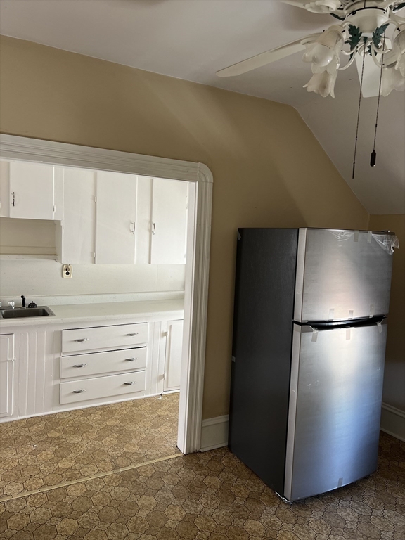 a white refrigerator freezer and a stove sitting inside of a kitchen